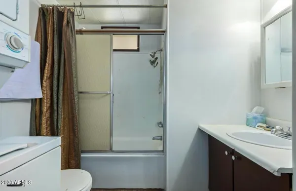 a white toilet sitting next to a shower curtain