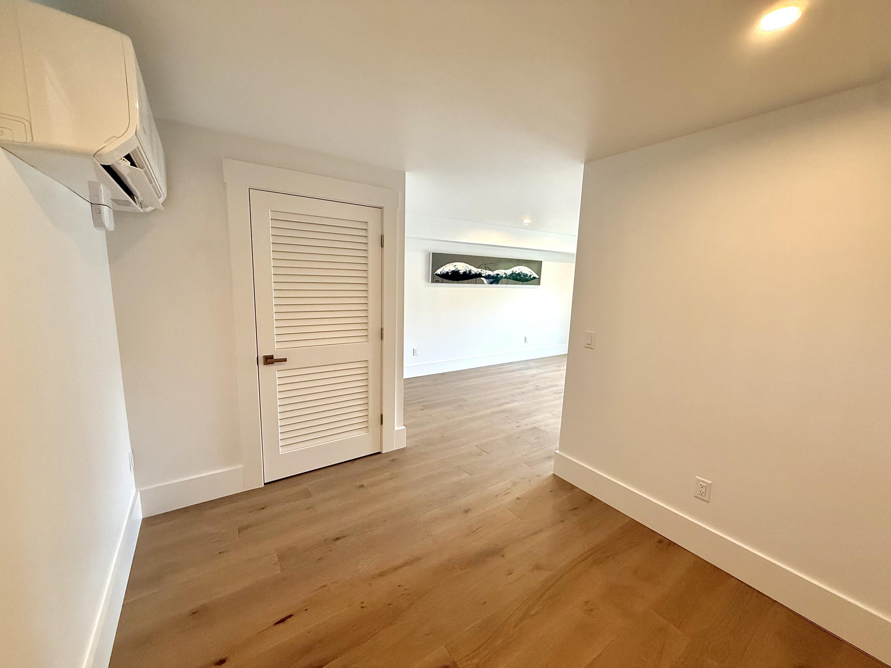 29 Cemetery Road, Unit 2 Provincetown, MA 02657 - Photo 11 of 30 an empty room with wooden floor and windows