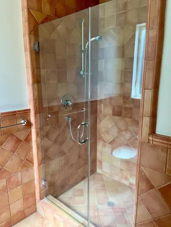 a view of an empty room with a fireplace and a window