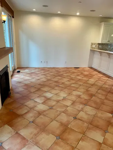 a large kitchen with stainless steel appliances kitchen island granite countertop a sink and cabinets
