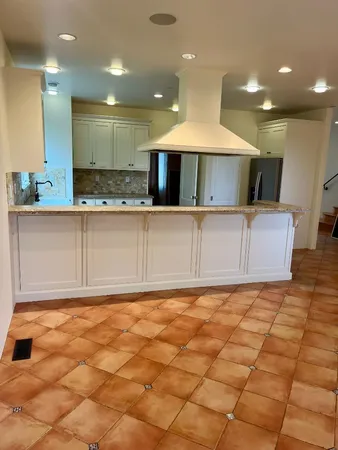 a kitchen with a stove a sink and a refrigerator