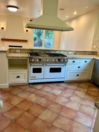 a kitchen with a stove and a refrigerator