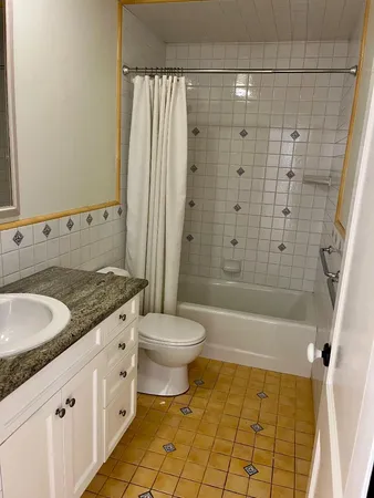 a view of empty room with window and wooden floor