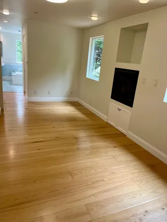 a view of empty room with wooden floor