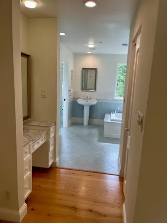 a bathroom with a sink a toilet and mirror