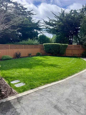 a view of yard with swimming pool and green space