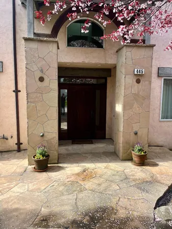 a front view of a house with a garden