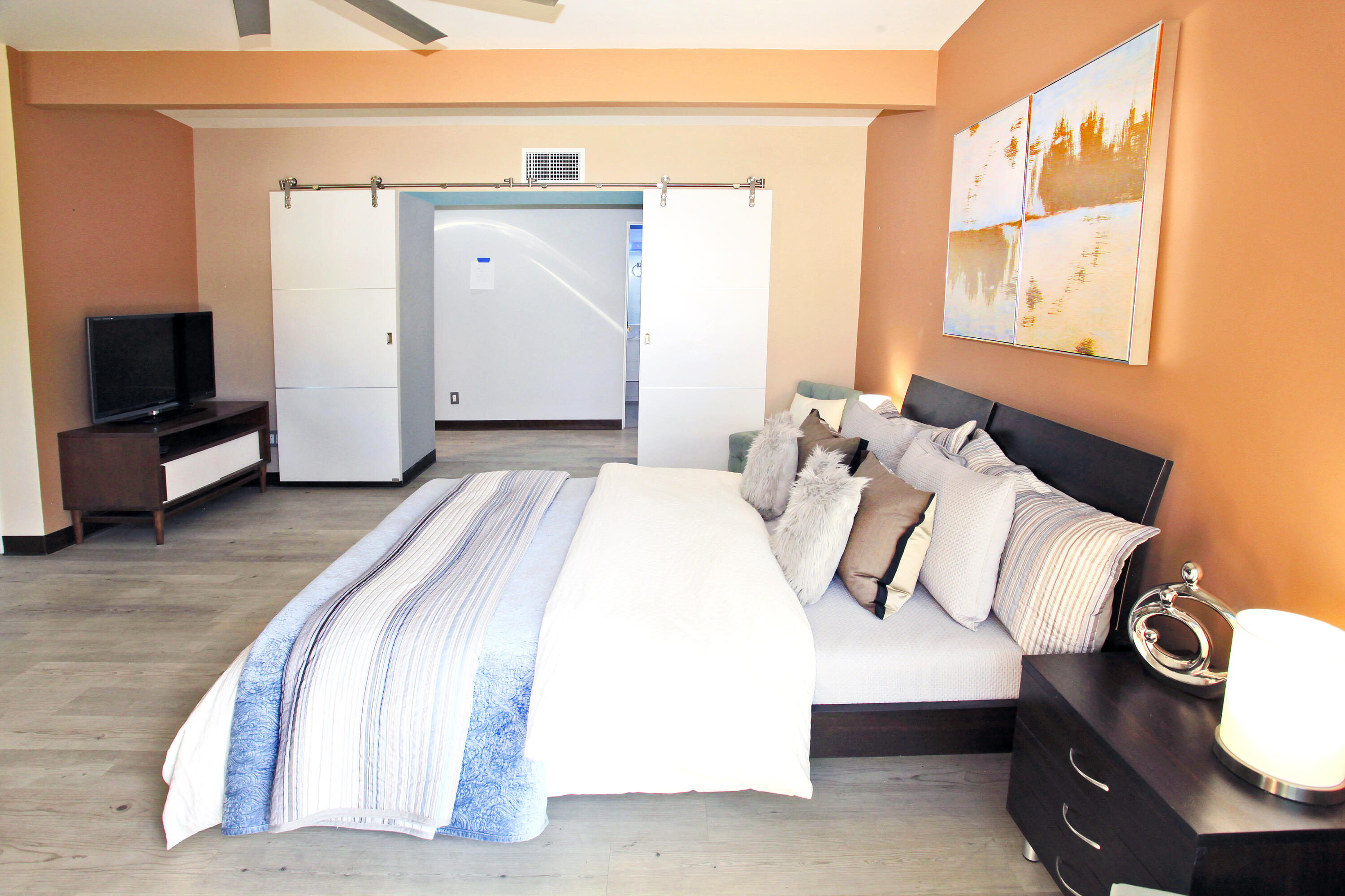 71991 Vista Del Rio Rancho Mirage, CA 92270 - Photo 19 of 34 a bedroom with a bed and a flat tv screen on a dresser