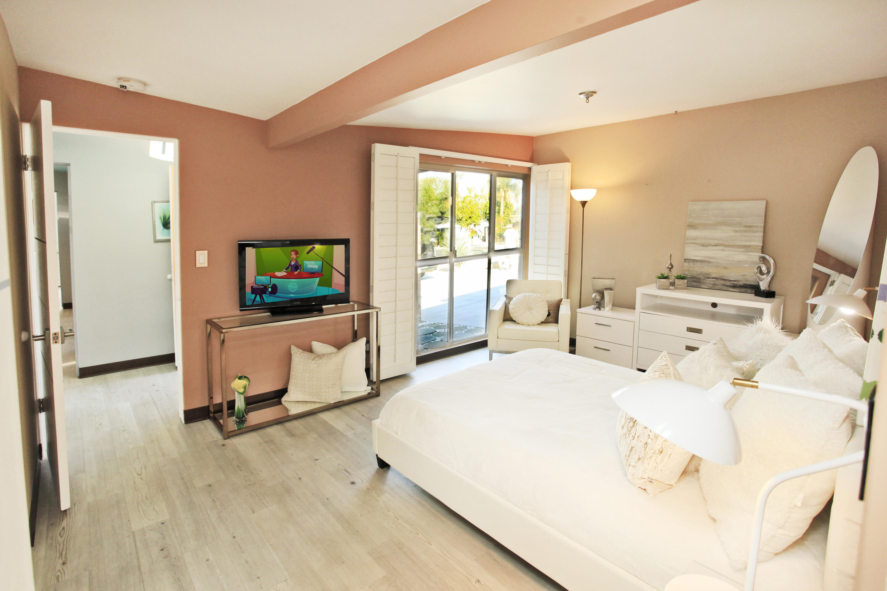 71991 Vista Del Rio Rancho Mirage, CA 92270 - Photo 24 of 34 a bedroom with a bed a flat screen tv and a couch
