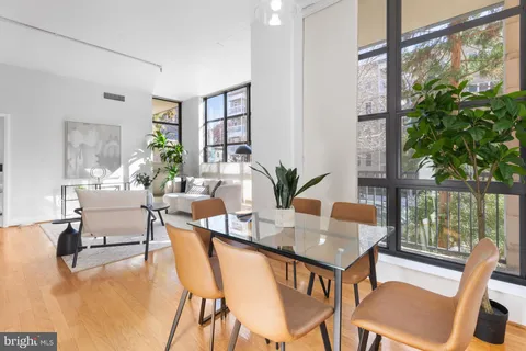 a dining room with furniture and wooden floor