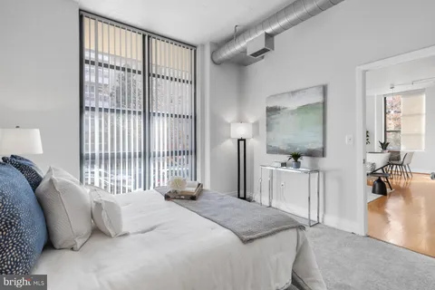 a bedroom with a bed and a chair