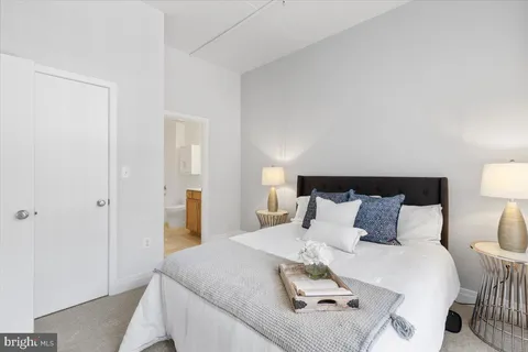 a bathroom with a toilet a sink a mirror and vanity