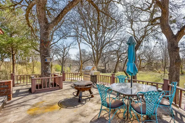 a view of swimming pool with deck and furniture
