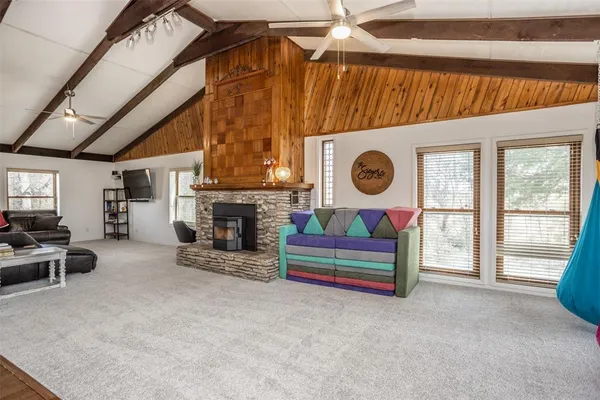 a living room with furniture a fireplace and a window