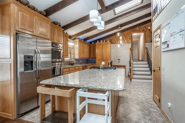 a kitchen with stainless steel appliances granite countertop a stove and a refrigerator