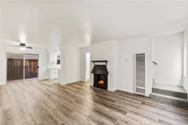 a view of empty room with a fireplace and window