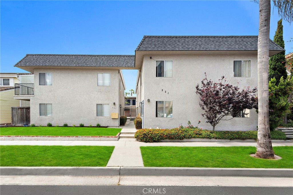 221 10th Street Huntington Beach, CA 92648 - Photo 4 of 20 a front view of a house with a yard and garage