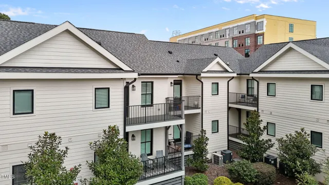 a view of a big house with wooden fence and large windows