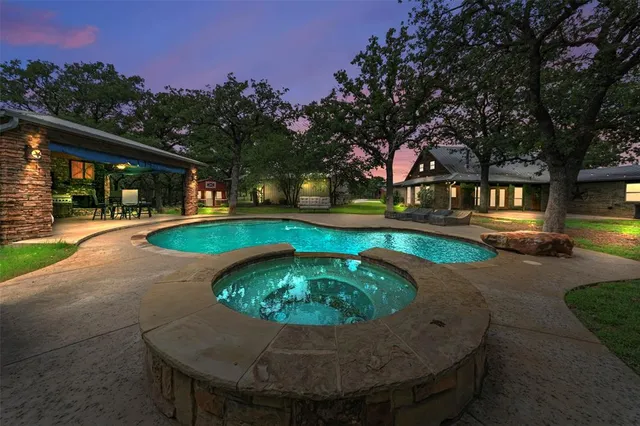 a swimming pool with outdoor seating and yard