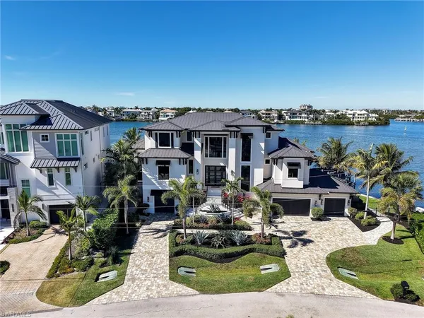 a front view of a house with a garden and sitting area