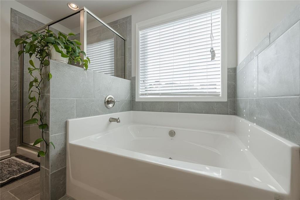 3593 Dover Run Lane Loganville, GA 30052 - Photo 33 of 54 a white bath tub sitting next to a shower