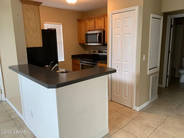 a kitchen with stainless steel appliances a refrigerator and a stove top oven