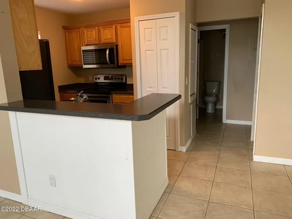 a kitchen with stainless steel appliances a refrigerator a stove a microwave and a sink