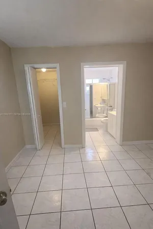 a view of an empty room and a bathroom