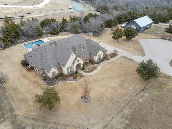 an aerial view of a house with outdoor space