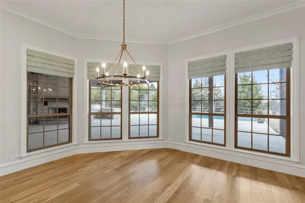 a view of an empty room with glass door and balcony
