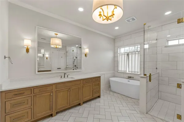 a spacious bathroom with a sink a mirror a bathtub and window