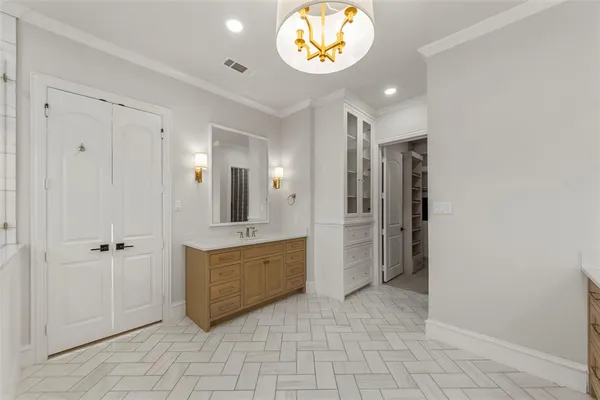 a view of an entryway with a cabinet and mirror