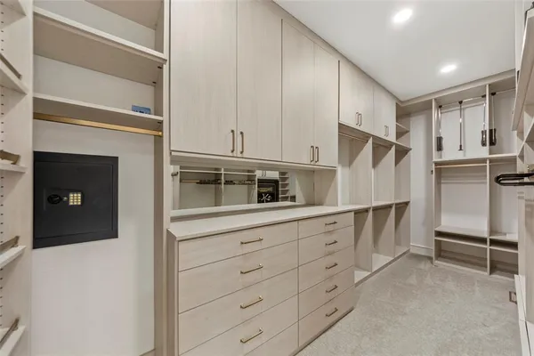a kitchen with granite countertop white cabinets and refrigerator