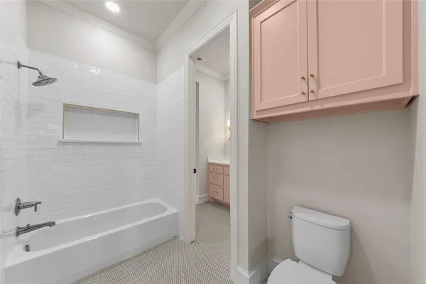 a bathroom with a toilet and a bathtub