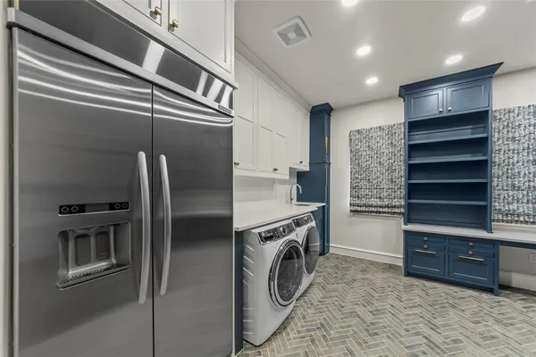 a kitchen with refrigerator and cabinets