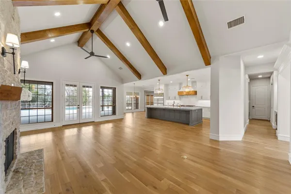 a view of a living room with hardwood floor and a large window