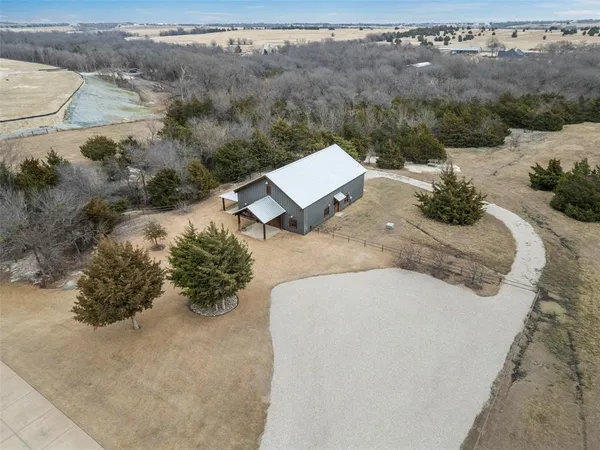 an aerial view of a house with a yard
