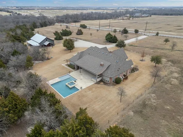 an aerial view of a houses with a yard