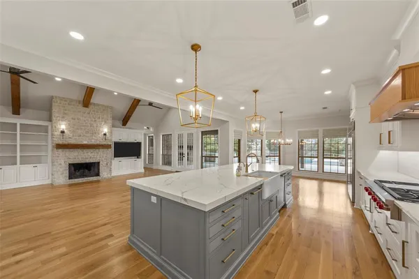 a large white kitchen with granite countertop lots of counter space