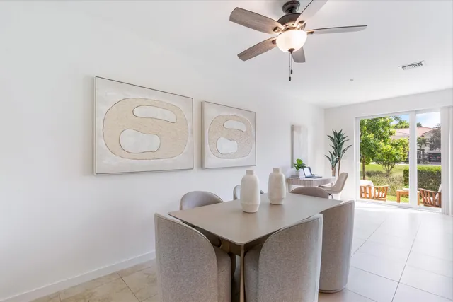 a view of a dining room with a table and chairs