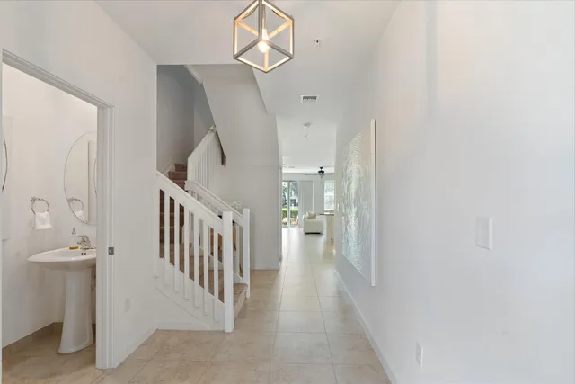 a view of a hallway with a white walls and stairs
