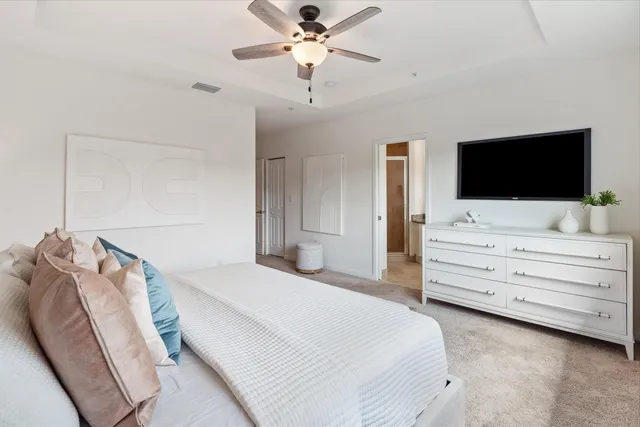 a bedroom with a bed and a flat screen tv