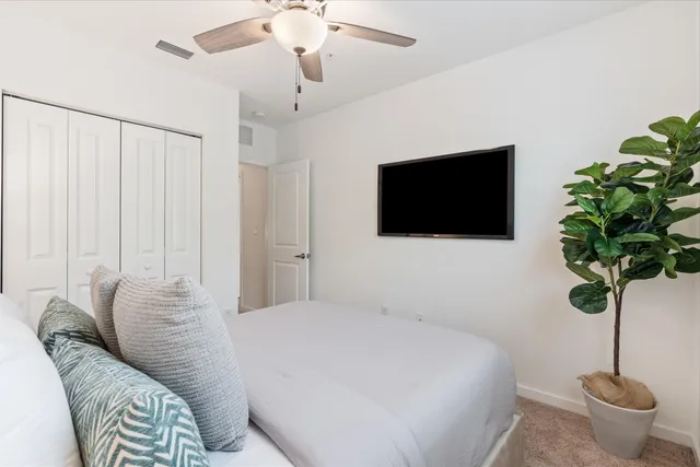 a bedroom with a bed and a flat screen tv