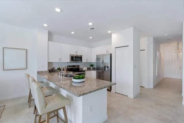 a kitchen with refrigerator and cabinets