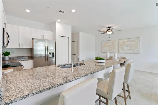 a kitchen with granite countertop a counter space cabinets stainless steel appliances and a sink