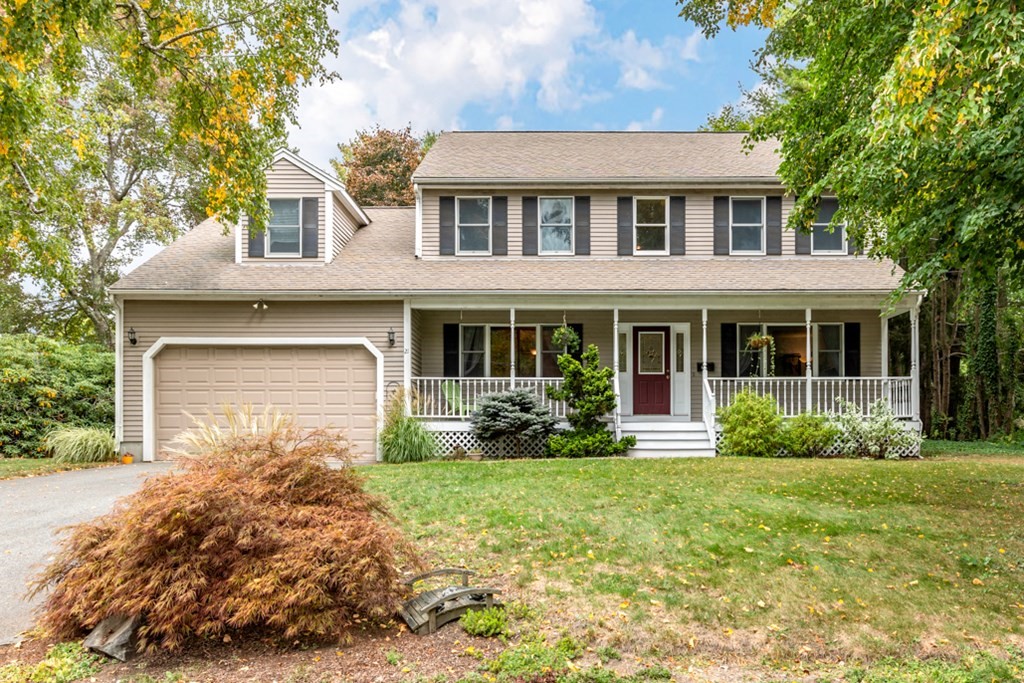 a front view of a house with garden and porch