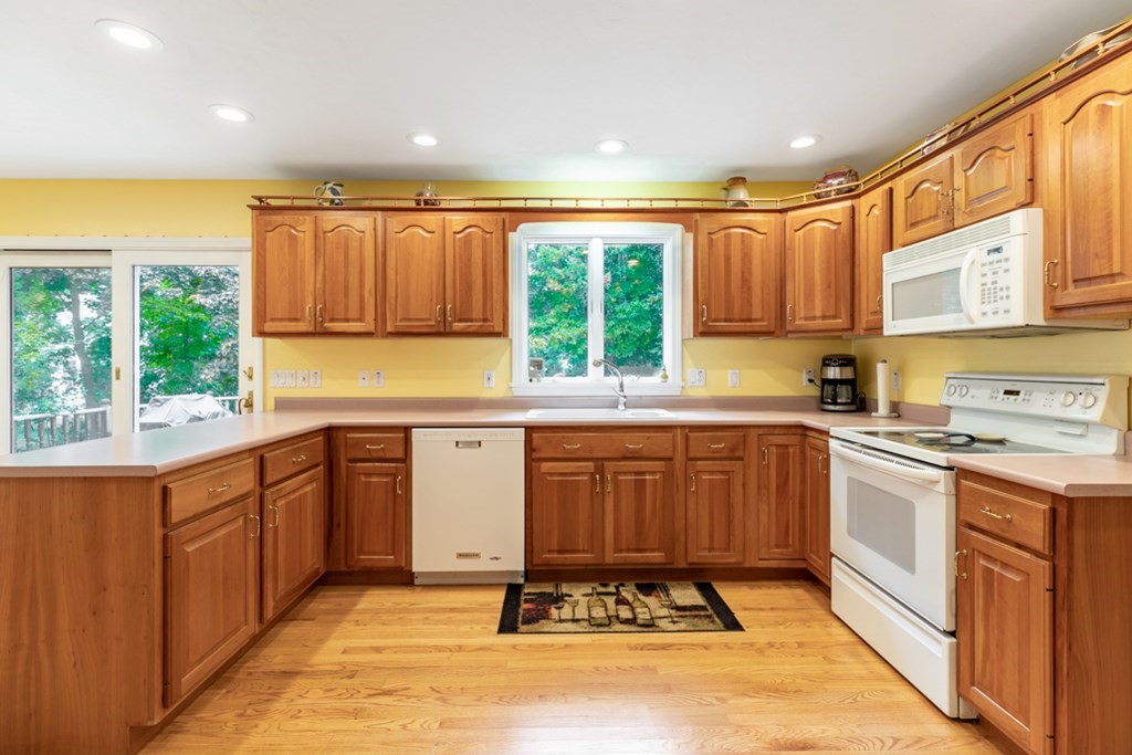 21 Longacre Road Needham, MA 02492 - Photo 13 of 41 a kitchen with stainless steel appliances granite countertop a stove a sink and a microwave