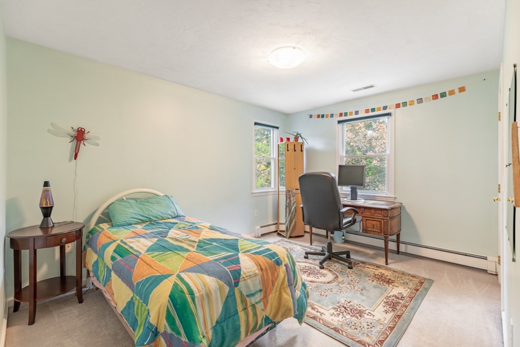 21 Longacre Road Needham, MA 02492 - Photo 28 of 41 a bedroom that has a bed and chair in it