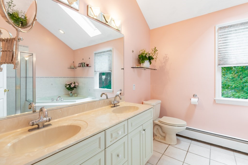 21 Longacre Road Needham, MA 02492 - Photo 32 of 41 a bathroom with a sink a toilet and a mirror