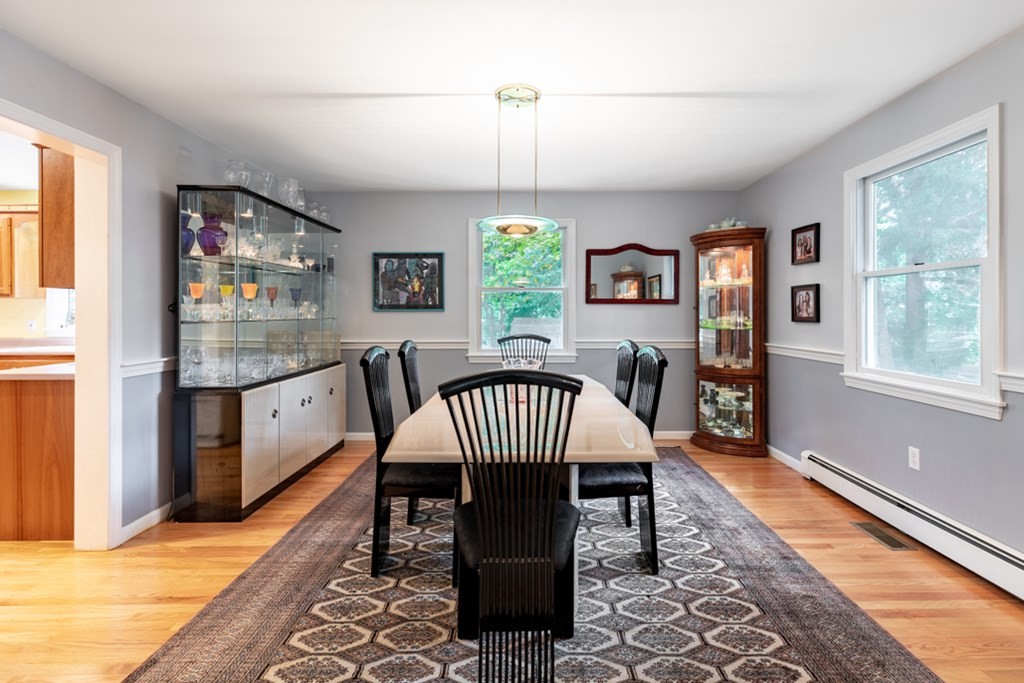 21 Longacre Road Needham, MA 02492 - Photo 9 of 41 a dining room with furniture a chandelier and wooden floor